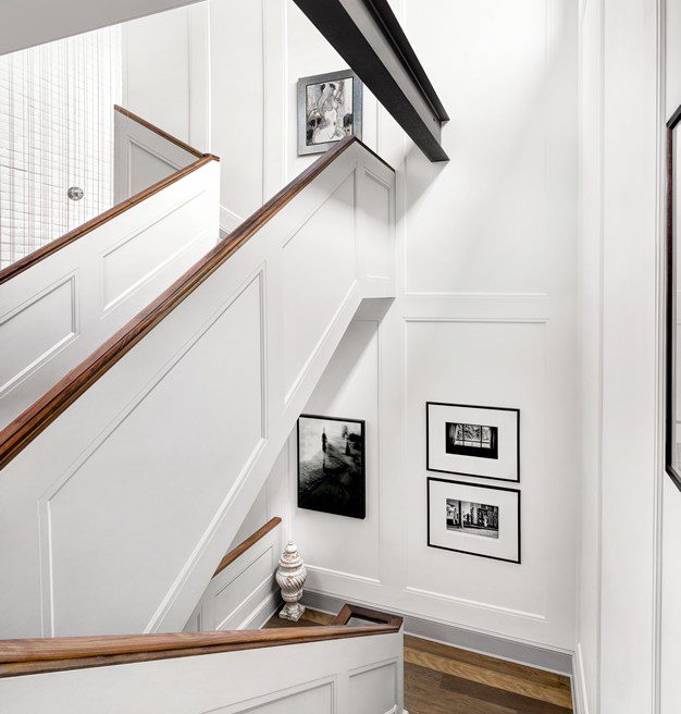 A white staircase with pictures on it.