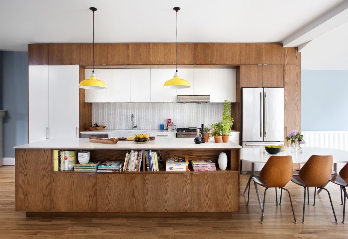 A modern kitchen with wooden cabinets and a wooden island.