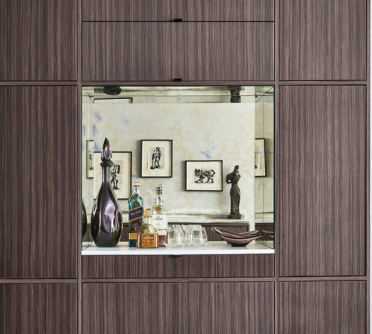 A wooden cabinet with a mirror in it.