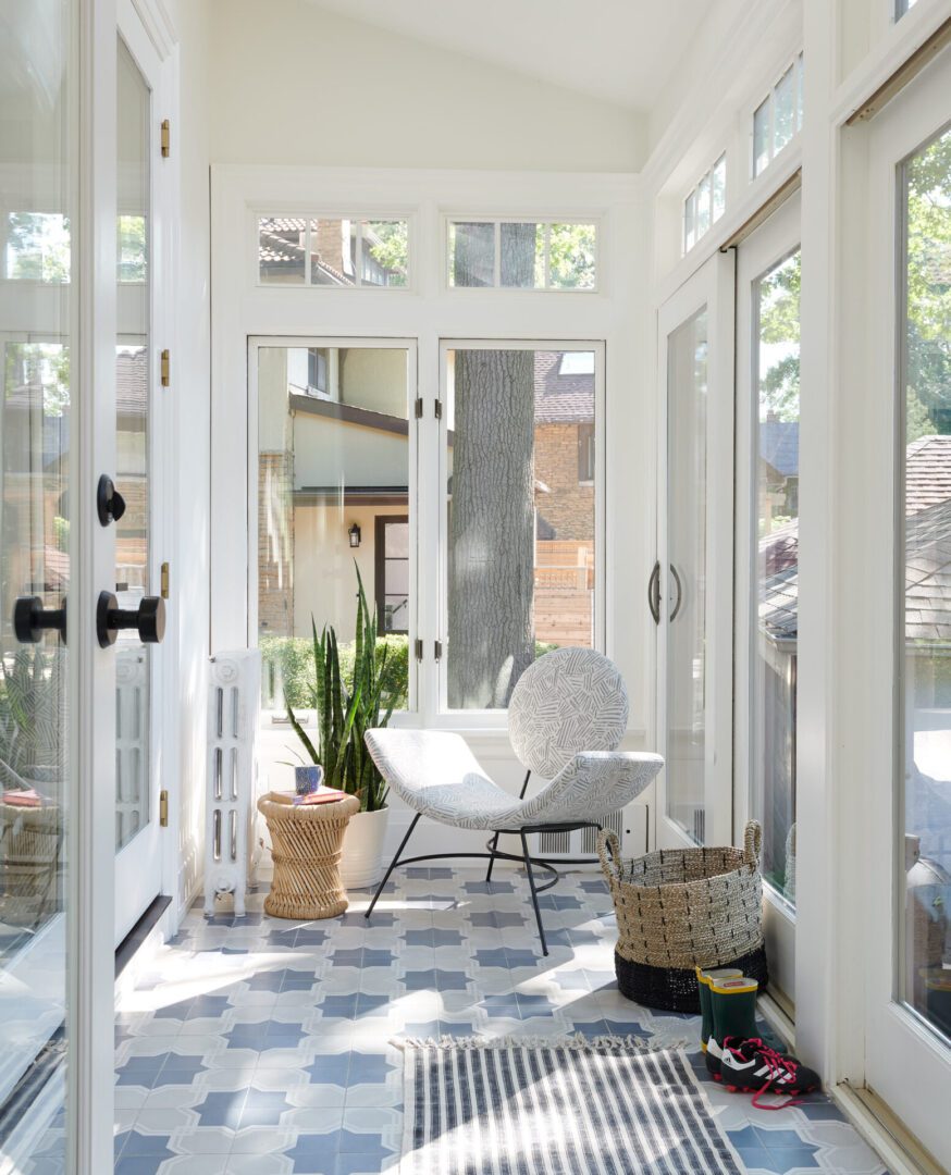 A white chair and some plants in a room