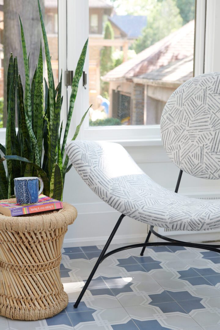 A chair and table with plants in the background