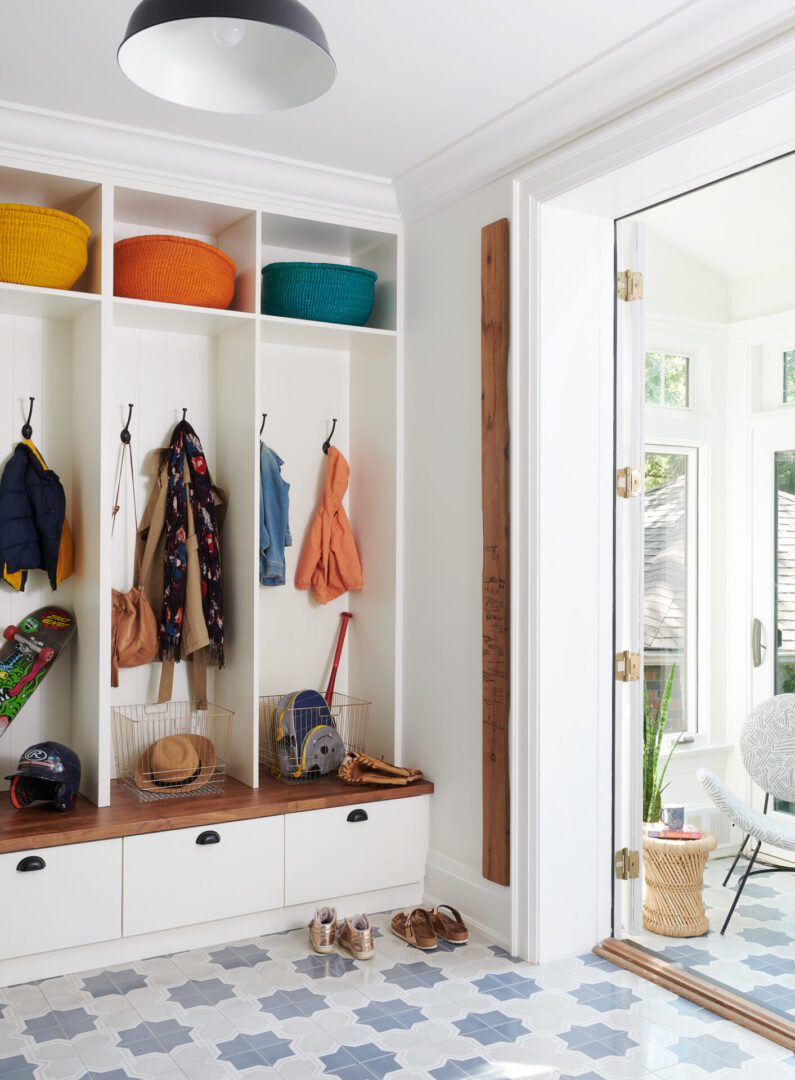 A white room with a lot of shelves and hooks